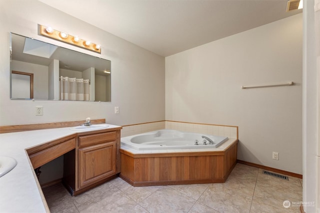 bathroom featuring vanity, tile patterned floors, and a tub to relax in