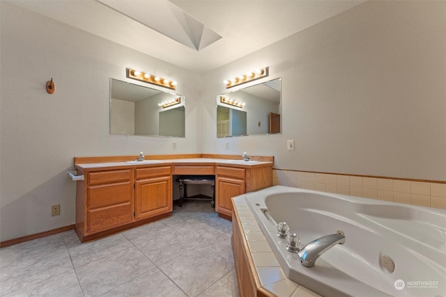 bathroom with tile patterned floors, vanity, and tiled tub