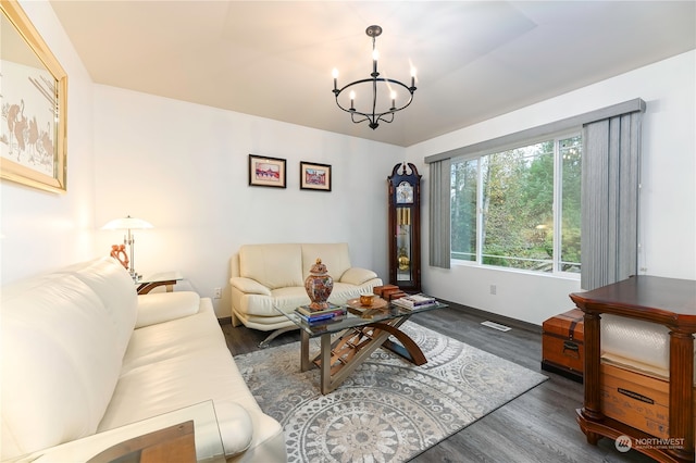 living room featuring dark hardwood / wood-style flooring and a chandelier