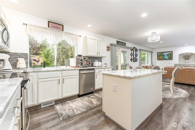 kitchen featuring white cabinets, plenty of natural light, and appliances with stainless steel finishes