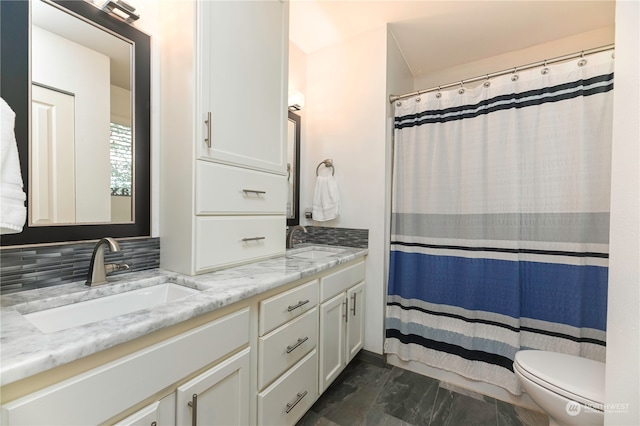 bathroom with toilet, curtained shower, vanity, and tasteful backsplash