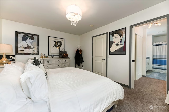 bedroom featuring connected bathroom and carpet flooring