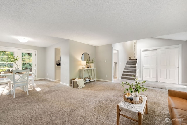 living room featuring carpet flooring and a textured ceiling