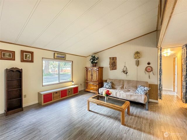 living room featuring crown molding, lofted ceiling, and hardwood / wood-style floors