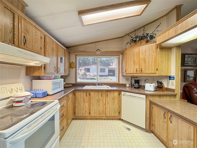 kitchen with white appliances, lofted ceiling, and sink