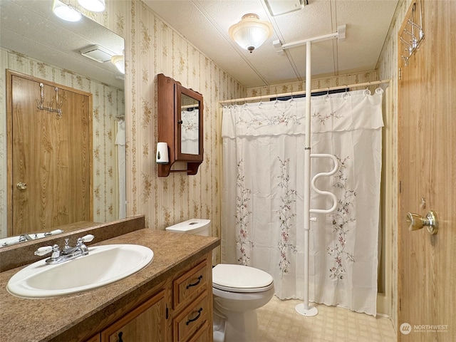 bathroom with vanity, a shower with shower curtain, and toilet