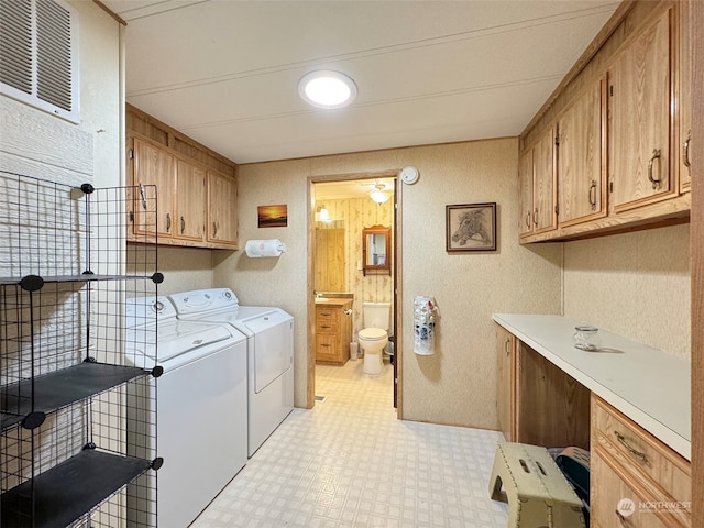 laundry room with cabinets and separate washer and dryer