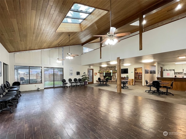 gym featuring wooden ceiling, hardwood / wood-style flooring, high vaulted ceiling, and a skylight