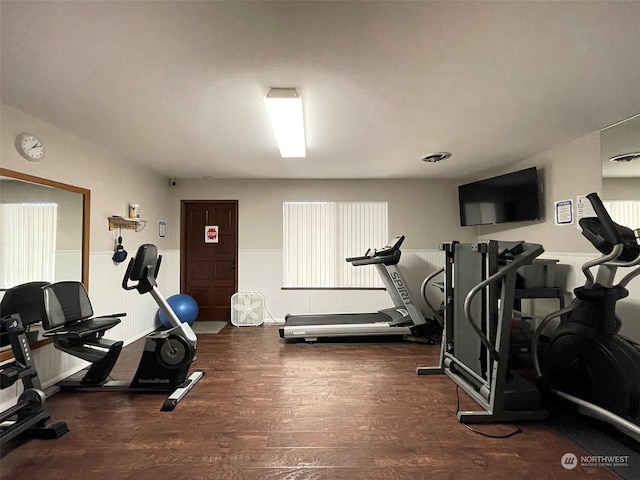 workout room with dark wood-type flooring