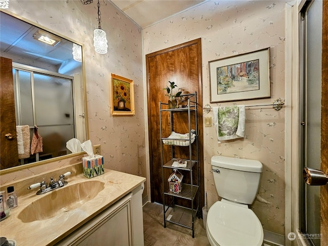 bathroom featuring toilet, a shower with shower door, and vanity