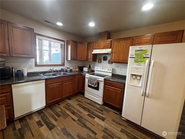 kitchen with dark hardwood / wood-style floors, sink, and white appliances