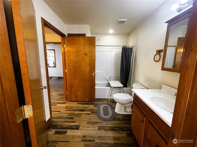 full bathroom with toilet, shower / bath combo, hardwood / wood-style flooring, and vanity