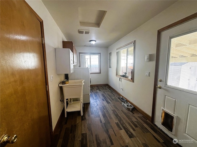 doorway with dark wood-type flooring