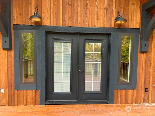 entryway featuring wooden walls and french doors