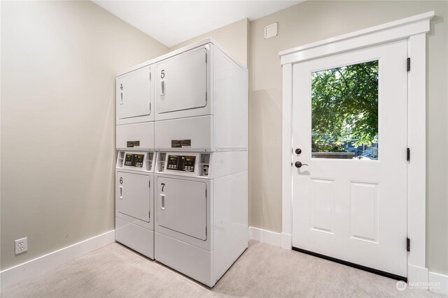 250 Tucker Ave Unit 24, Friday Harbor, WA 98250 - shared laundry featuring stacked washer / dryer, baseboards, and washing machine and clothes dryer