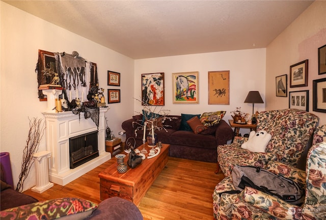 living room with light hardwood / wood-style floors and a textured ceiling