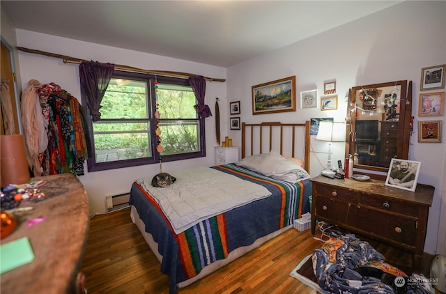 bedroom featuring baseboard heating and dark wood-type flooring