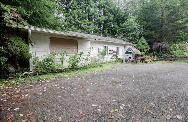 view of property exterior with an outbuilding and a garage