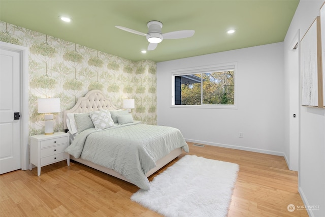 bedroom with ceiling fan and light hardwood / wood-style floors