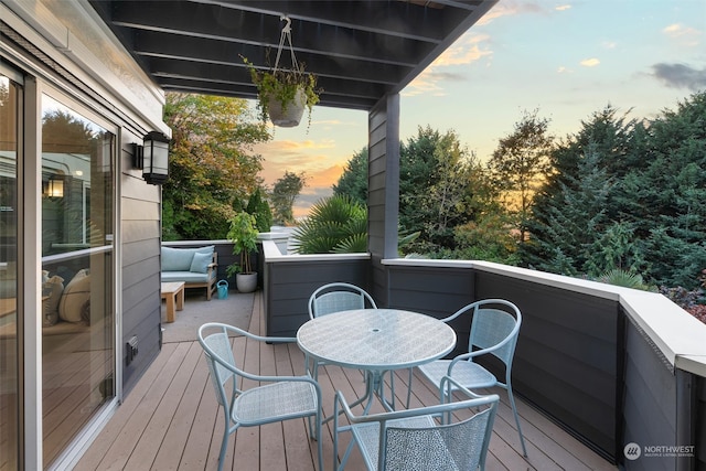 deck at dusk with outdoor lounge area