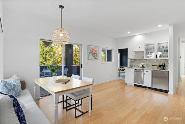 dining space with a chandelier and light hardwood / wood-style floors