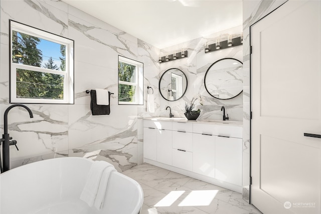 bathroom featuring vanity, a tub, a healthy amount of sunlight, and tile walls