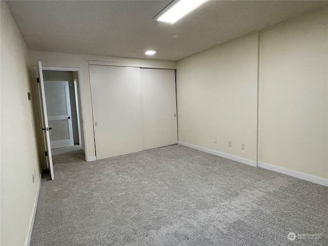 interior space with light colored carpet and a textured ceiling