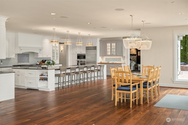 dining area with a chandelier and dark wood-type flooring