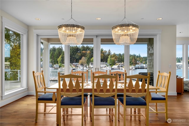 dining space featuring a water view and plenty of natural light