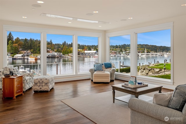 sunroom / solarium featuring a water view