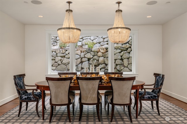 dining area featuring a notable chandelier and hardwood / wood-style floors