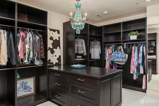 spacious closet featuring light carpet and a notable chandelier