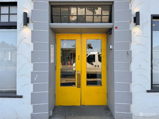 view of exterior entry featuring french doors