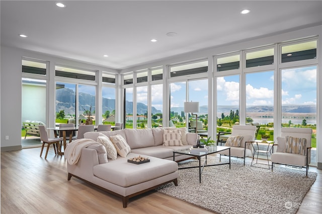 sunroom featuring a mountain view and a healthy amount of sunlight