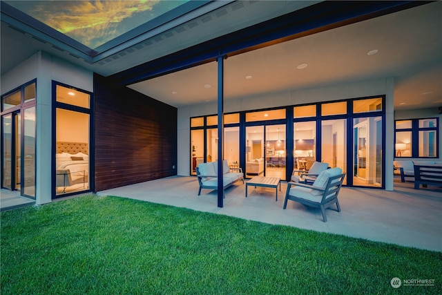 rear view of house featuring a patio area, a lawn, and an outdoor living space