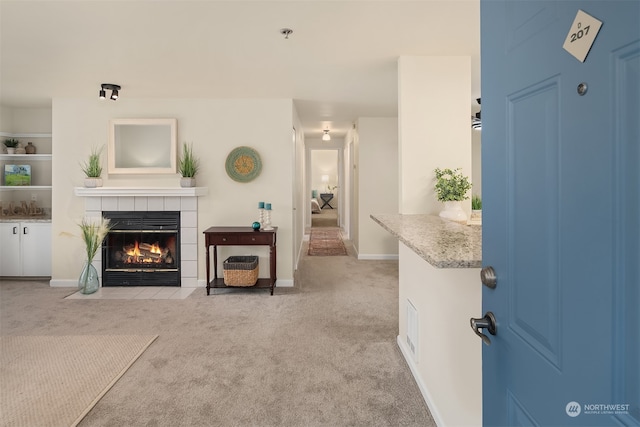 living room featuring light colored carpet and a fireplace