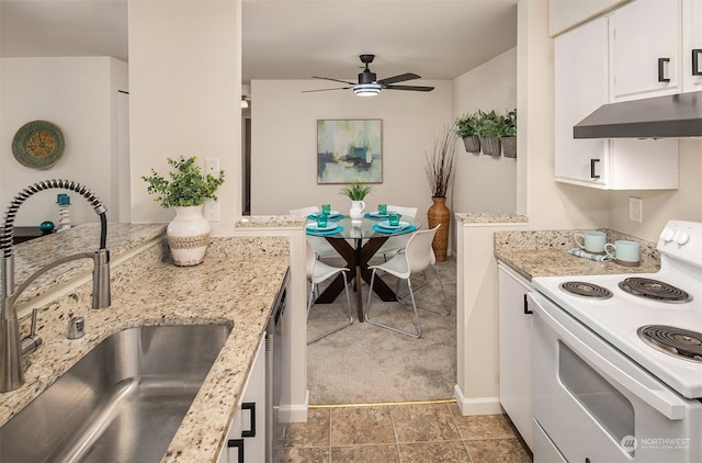 kitchen featuring white electric stove, sink, light stone countertops, light tile patterned floors, and white cabinets