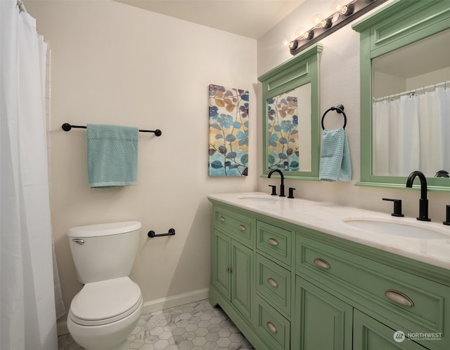 bathroom with toilet, vanity, and tile patterned flooring