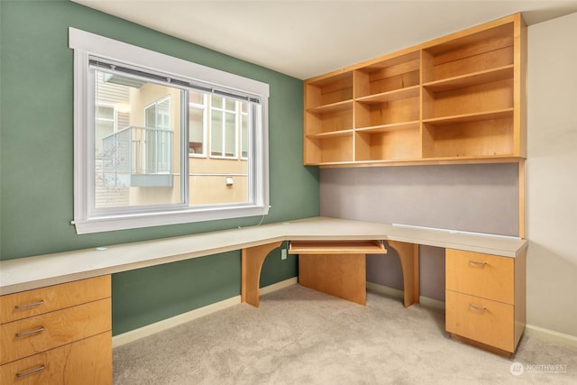 carpeted home office with built in desk