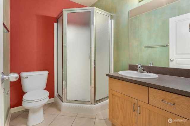 bathroom featuring vanity, toilet, tile patterned floors, and walk in shower