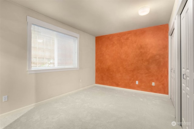 unfurnished bedroom featuring light carpet