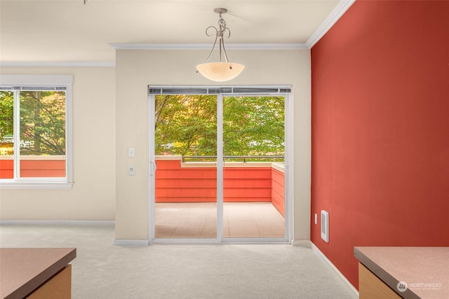 doorway featuring ornamental molding and carpet floors