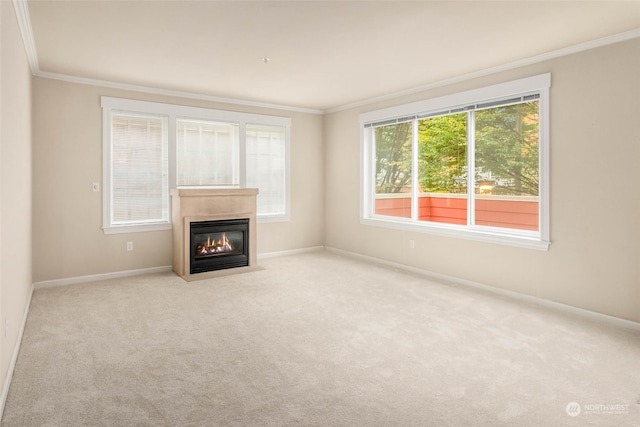 unfurnished living room featuring crown molding and light colored carpet