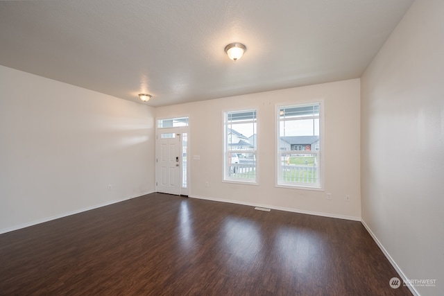 entryway with dark hardwood / wood-style flooring