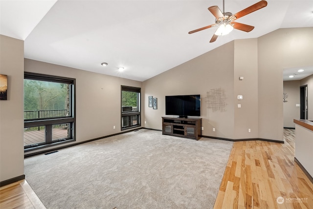 37122 237th Pl SE, Enumclaw, WA 98022 - unfurnished living room featuring healthy amount of natural light, light wood-style flooring, a ceiling fan, high vaulted ceiling, and light colored carpet