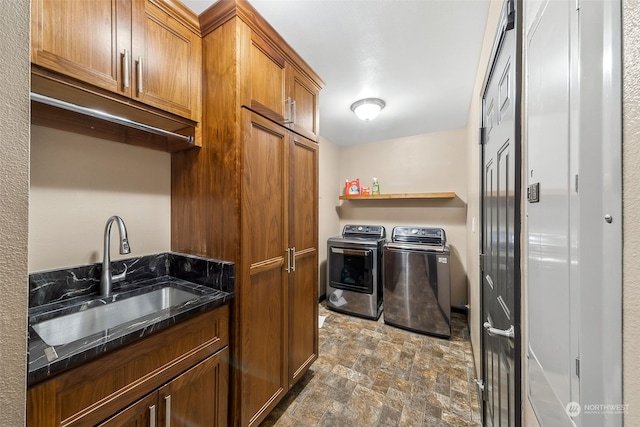 clothes washing area featuring separate washer and dryer and sink