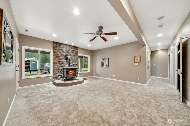 37122 237th Pl SE, Enumclaw, WA 98022 - unfurnished living room featuring a wood stove, light carpet, ceiling fan, and recessed lighting