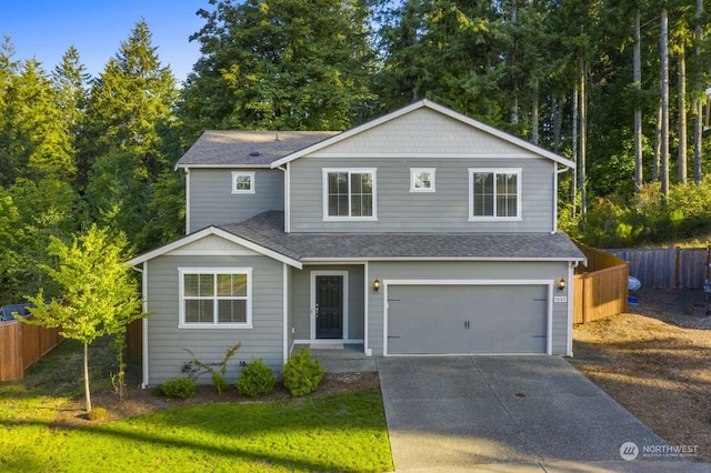 front of property featuring a front lawn and a garage