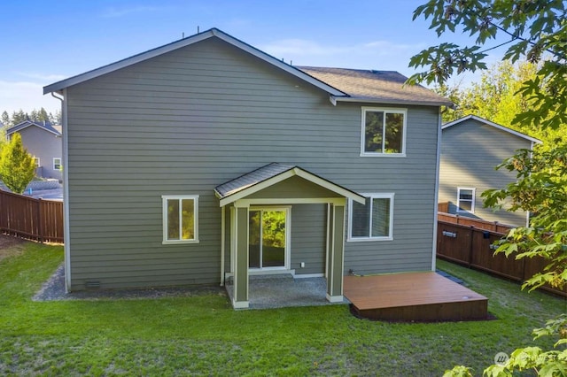 back of house with a wooden deck and a yard