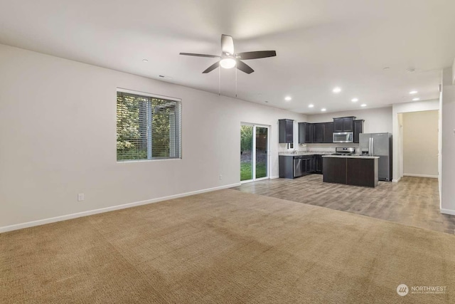 living room featuring carpet and ceiling fan